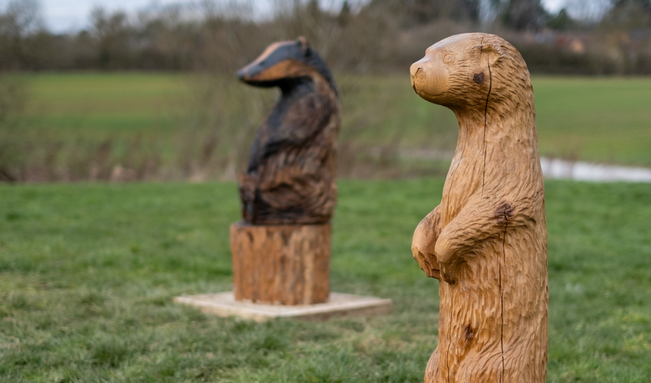 Two adorable woodland creatures native to the area made by a chainsaw carver 
