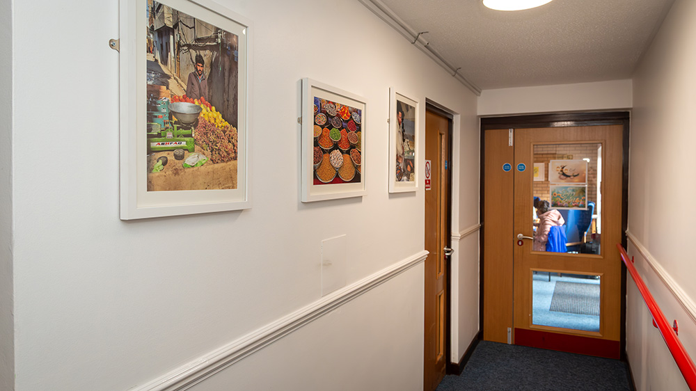 A hallway with pictures on the wall